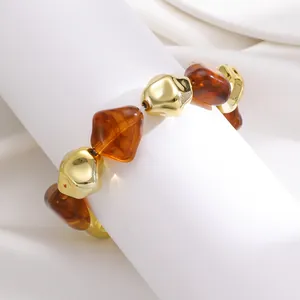 Detailed macro view of a retro Maillard style bracelet with irregular resin and gold CCB beads