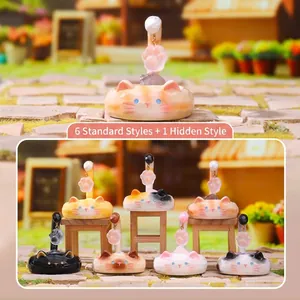 Detailed view of seven cute cat blind box figurines arranged in a miniature garden scene