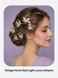 Elegant bridal hairpins set with golden leaves and pearls on model hairstyle