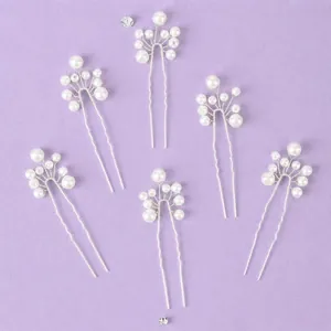 Set of 6 elegant minimalist bridal hair pins with white pearls on a textured purple background