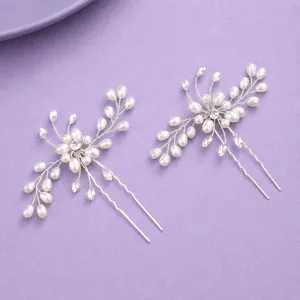 Elegant handmade bridal hair pins set with pearls and crystals on purple background
