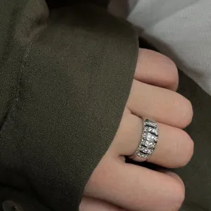 Detail view of a silver-plated wide fashion ring with multi-row sparkling stones.