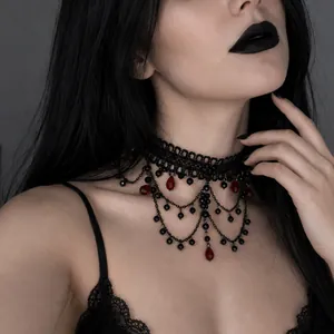 Close-up of gothic black lace choker with red crystal teardrop tassels