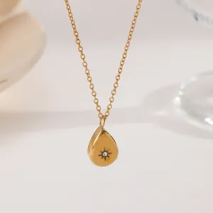 Minimalist gold-plated teardrop pendant necklace featuring starburst zircon engraving