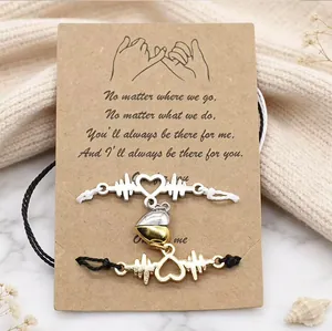 Detailed view of the magnetic ECG heart couple bracelets on a kraft sentiment card