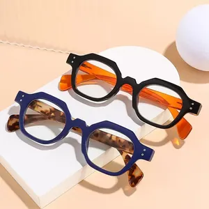 Retro chunky hexagonal reading glasses with tortoiseshell and orange temples in studio light