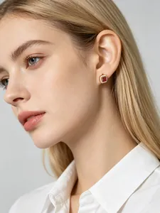 Close-up of a female model wearing square red zircon stud earrings crafted in s925 silver.
