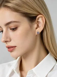 Close-up detail showing a square purple zirconia halo stud earring on a female model