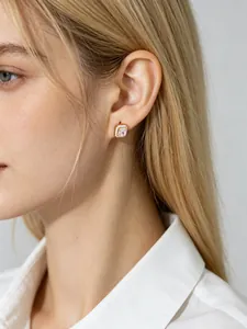 Premium detail view of square CZ sterling silver stud earrings worn on a female model's ear
