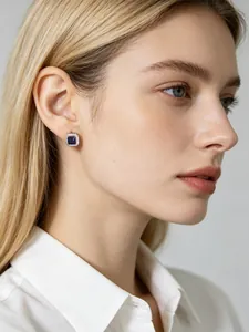 Detailed close-up showing elegant square blue sapphire zircon stud earrings on a female model