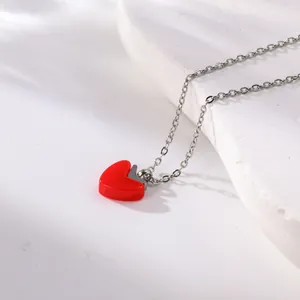 Detailed close-up view of a vibrant red oil-drop heart pendant on a silver steel chain