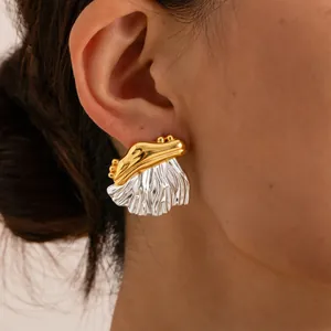 Close-up detail of a unique two-tone 18K gold plated stainless steel statement earring