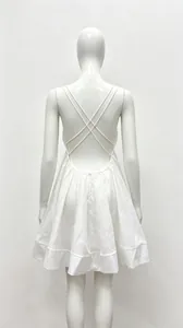 Detail view of the white backless dress back with delicate cross-strap design.