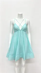 Close-up of light blue spaghetti strap mini dress with deep V-neck and pleated skirt
