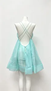 Detailed rear view of a light blue backless flared mini dress with cross-back straps