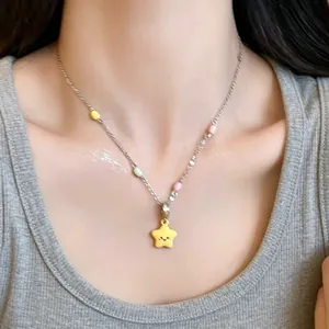 Close-up of minimalist silver chain necklace with a cute smiling yellow star pendant.