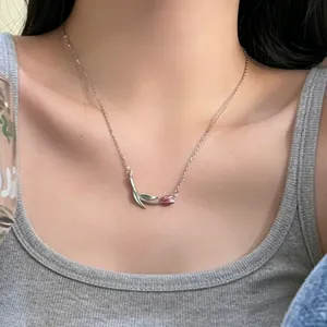 Close-up of an elegant pink tulip flower pendant necklace on a fine silver chain