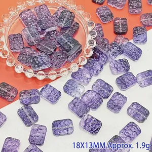Macro detail of 18x13mm purple glass flower plaque beads for DIY jewelry crafting