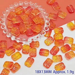 Detailed macro shot of 18x13mm orange gradient glass flower beads for jewelry making