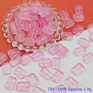 Close-up macro view of pink floral patterned rectangular beads for DIY handmade jewelry