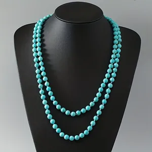 Vintage double-layer turquoise bead necklace with handmade knots displayed on a bust.