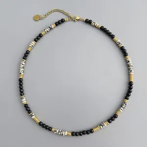 Close-up of handmade stone beaded necklace with leopard print and gold spacers.