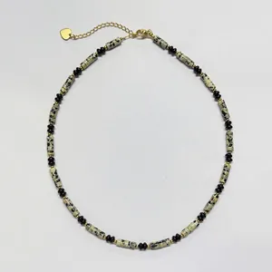 Detail of a beaded necklace with dalmatian jasper and black accents
