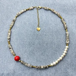Mixed material choker with spotted stone beads, pearls and a vibrant red accent bead