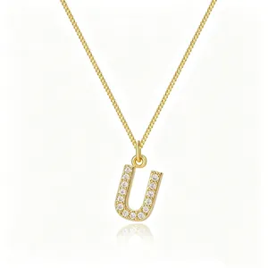 Close-up of gold-plated letter U pendant with cubic zirconia on a box chain