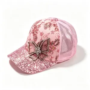 Close-up view of the rhinestone butterfly and sequin brim on pink mesh baseball cap