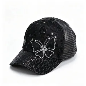 Detail view of black mesh baseball cap with rhinestone butterfly and sequin accents