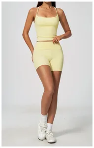 Front view of a light yellow yoga set including a sports tank top and matching shorts