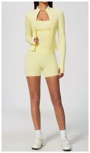 Three-piece yellow yoga set including a jacket, sports top, and high-waisted shorts