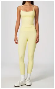 Woman wearing a pale yellow yoga set with tank top and leggings for fitness training