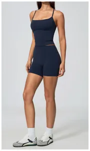 Detail view of a navy blue yoga tank top and high-waist shorts on a fitness model