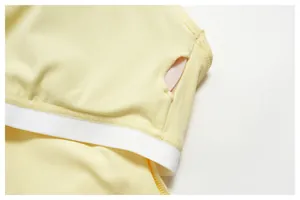 Close-up of pale yellow yoga sports bra fabric showing padding insertion slot detail