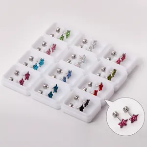 Detailed view of colorful star rhinestone stud earrings with screw backs in white boxes.