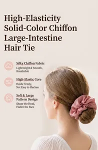 Close-up of a high-elasticity pink chiffon scrunchie worn on a model's hair bun.
