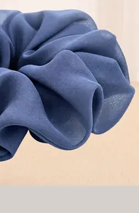 Macro detail of high-elastic solid color chiffon scrunchie showing fine fabric texture