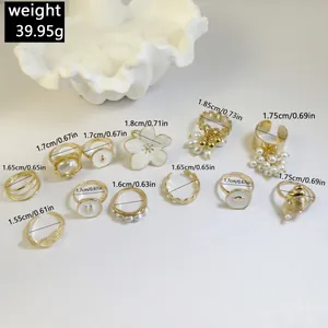 Close-up of 12-piece gold Baroque pearl ring set with dimensions and weight data