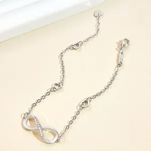 Detail view of infinity symbol bracelet with heart charms and sparkling zircon inlay.