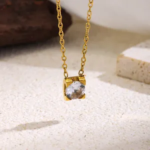 Detailed view of a gold titanium steel necklace featuring a single round zircon pendant.