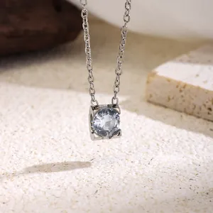 Detailed view of a four-prong round zircon pendant on a titanium steel chain