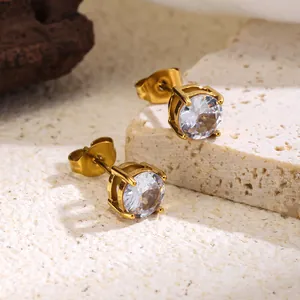 Macro detail of classic 4-prong stud earrings with sparkling cubic zirconia stones.