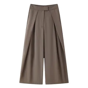 High-quality detail view of stylish brown wide-leg pleated trousers with elegant drape