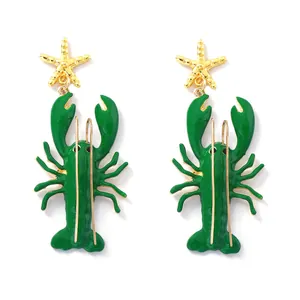 Grüne Emaille-Hummer-Ohrringe mit goldenem Seestern und langen Barthaaren auf weiß.