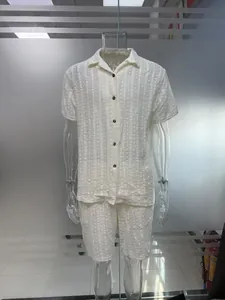 White hollow textured short sleeve shirt and matching shorts set on transparent mannequin