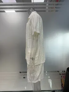 Side view of men's summer hollow-out textured short sleeve shirt and shorts beach set in white