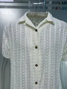 Close-up of men's white short-sleeved shirt with breathable hollow eyelet texture