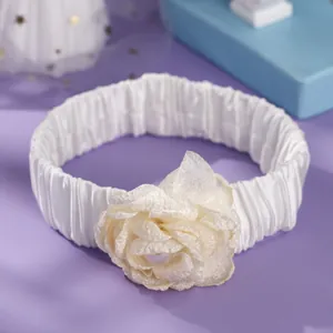 Elegant white elastic bridal garter with beige fabric rose and pearl detail